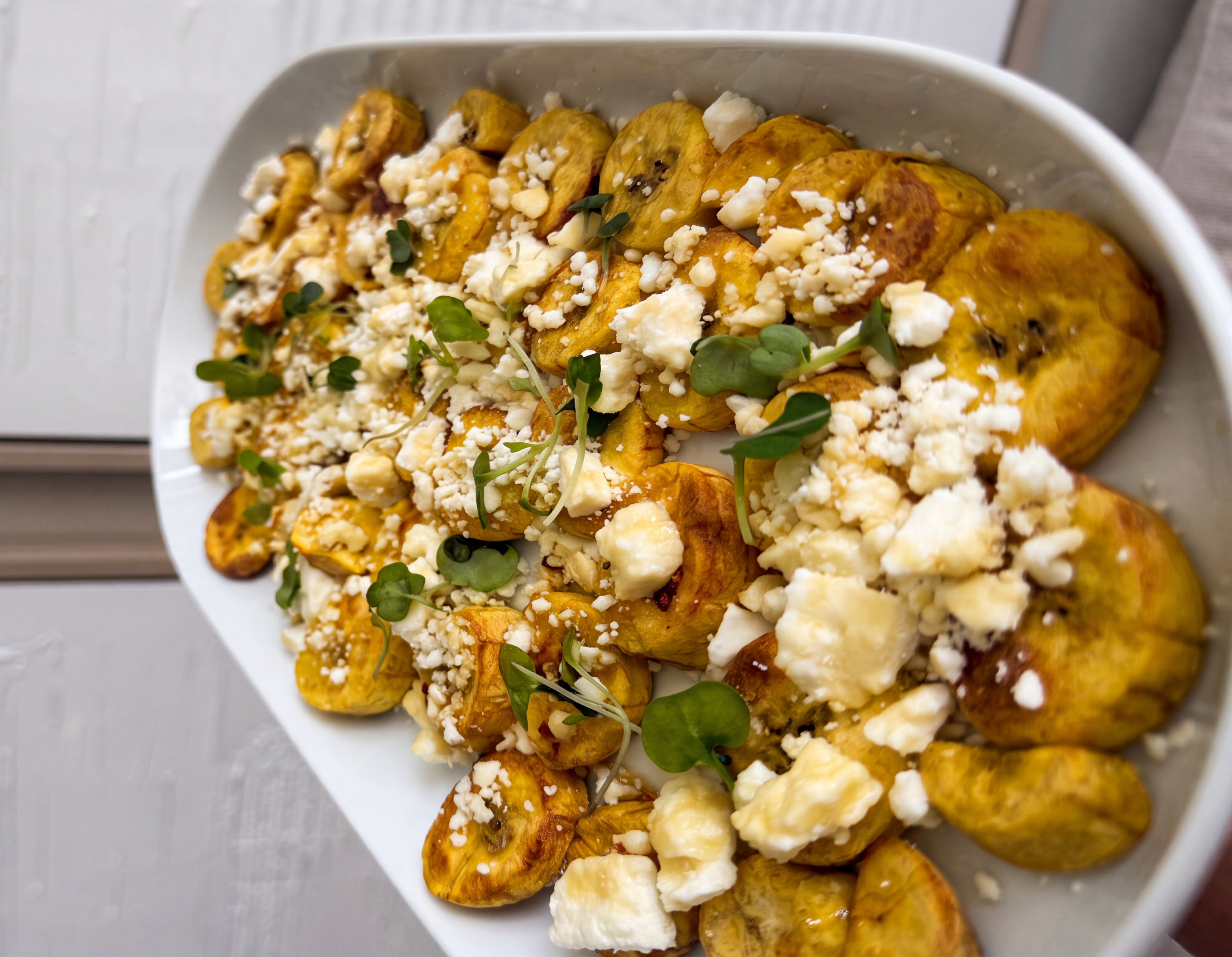 Green plantain bites with feta and spicy honey